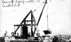 G-5925.1FF3-11 Placing rock for apron on Gulf side of Seawall before wall is constructed