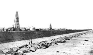 G-5925.3FF6-6 Two men standing on riprap at base of Seawall