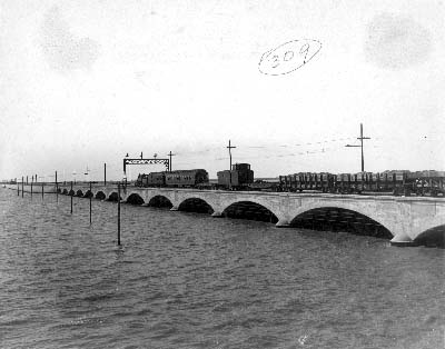 Photograph of work train proceeding across causeway