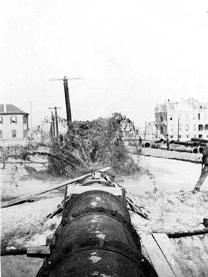 Grade Raising, Photograph looking down pipeline discharging fill in vicinity of Rosenberg Women's Home