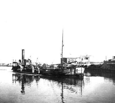 Photograph of dredge moored in canal
