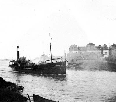 Photograph of Dredge Triton proceeding through canal 
