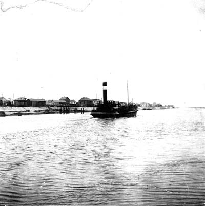 Photograph of dredge proceeding through canal 