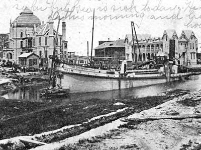 Photograph labeled Dredge Boat Holm dredging the Galveston Grade Raising Canal 