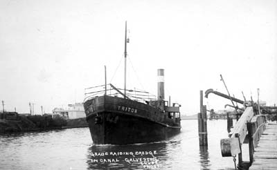 Photograph labeled Grade Raising Dredge in Canal 