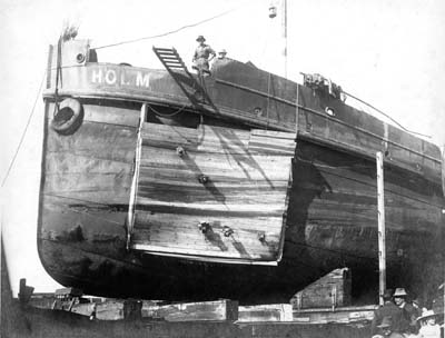 Grade Raising, Photograph of Dredge Holm in drydock following marine accident