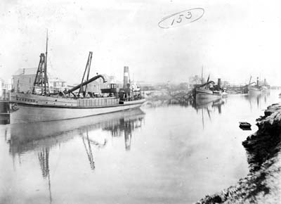 Grade Raising, Photograph of four dredges discharging fill along canal
