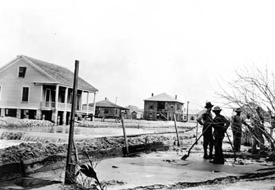 Grade Raising, Photograph of workmen standing in area being filled 