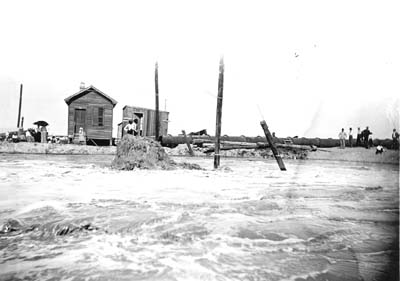 Grade Raising, Photograph of workmen on embankment watching pumping of fill 