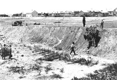 Grade Raising, Photograph of horse-drawn graders smoothing embankment 