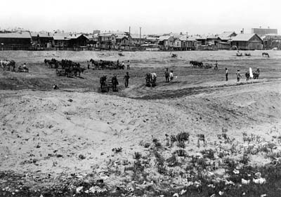 Grade Raising, Photograph of workmen grading area awaiting fill 