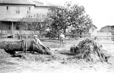Grade Raising, Photograph of two boys plaing about pipeline discharging fill 