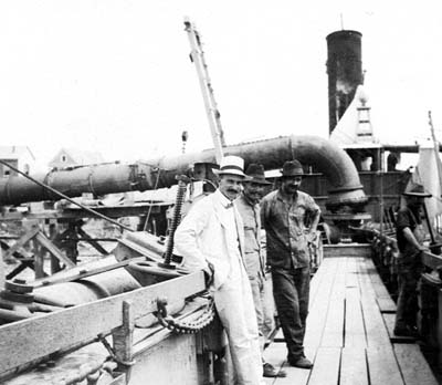 Grade Raising, Photograph of three men standing on walkway