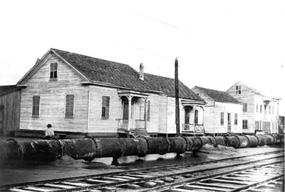 Photograph of pipeline running between streetcar tracks and houses