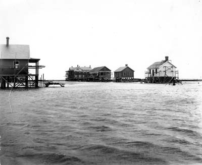 Photograph of raised houses being filled 