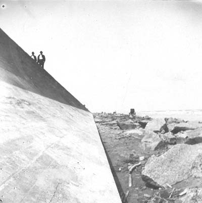 Seawall, Photograph of two men walking on top of Seawall