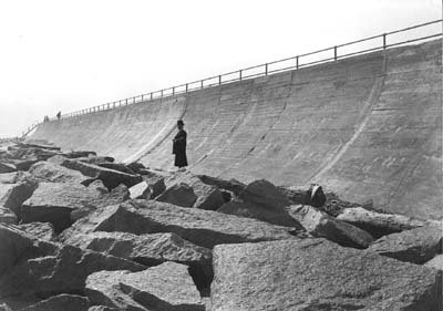 Seawall, Photograph of man standing on riprap in front of Seawall