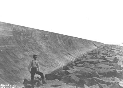 Seawall, Photograph of man posed standing on riprap