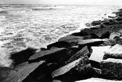 Seawall, Photograph of waves crashing against riprap 