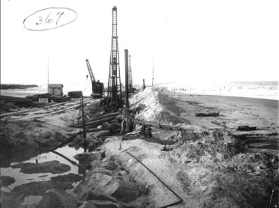 Seawall, Photograph labeled Showing Gulf & Bay with construction equipment