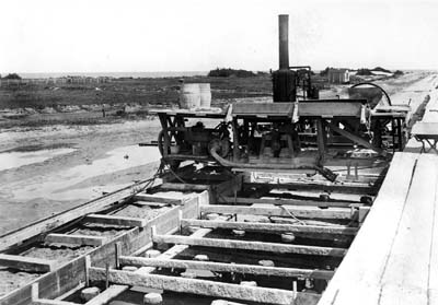 Seawall, Photograph of steam mixer laying foundation for Seawall 