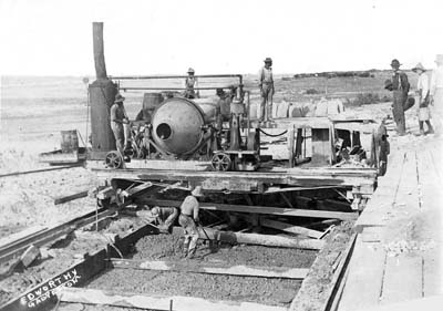 Seawall, Photograph of workmen pouring and spreading concrete for foundation