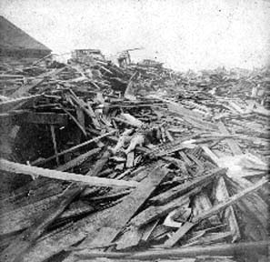 Photograph of body partially covered by debris
