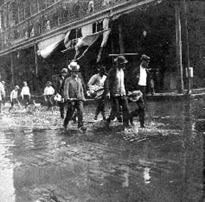 Photograph labeled Strand Bet 20 & 2. Searching out the dead Sunday Morning Sept 9, 1900