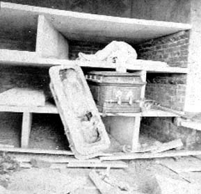 Photograph of casket resting on shelves