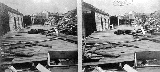 Stereo card card of body laying amid debris and wrecked houses