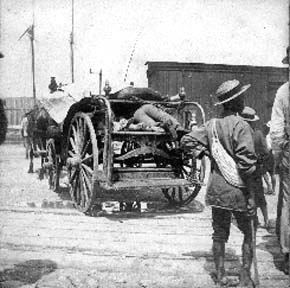 Photograph labeled 22nd & wharf. Hauling dead to barge