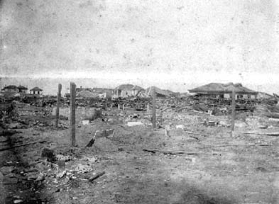 Photograph labeled Temporary Graves along the barren shores, once adorned with beautifulhomes