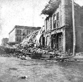 Photograph of partially collapsed commercial building