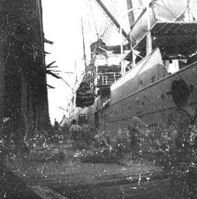 Photograph labeled Foot of 20th St. Unloading Government supplies for the starving people of Galveston