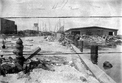 Photograph labeled Wrecked Boast in front Mallory Line shed