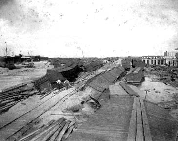 Photograph of wrecked and overturned freight cards in freight yard