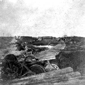 Photograph of freight car truck and ties washed out by hurricane