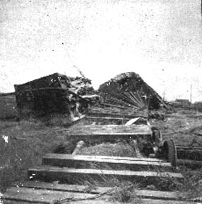 Photograph labeled Switch yards. Overturned cars of wheat.