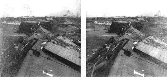Stereo card of overturned freight cars