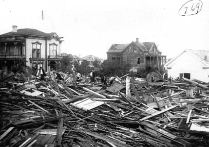 Photograph of workers walking through debris