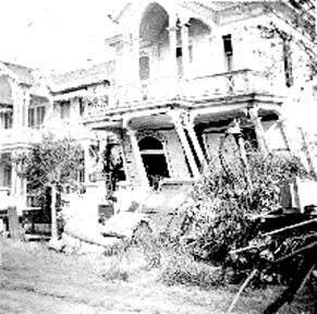 Photograph of house with damaged first-floor balcony
