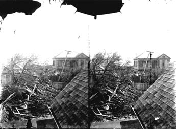 Stereo glass negative of residential damage viewed from roof of house