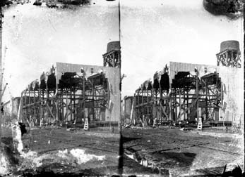 Stereo glass negative of two-story damaged building
