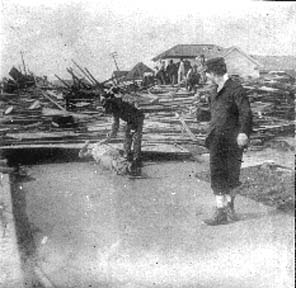 Photograph labeled Clearing Debris West
