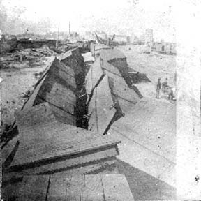 Photograph labeled East yards. Elevators & jail in background