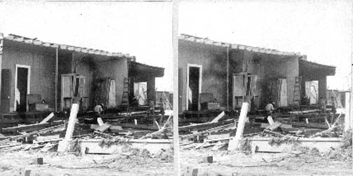 Stereo card of interior view of building with collapsed wall