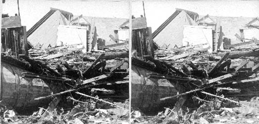 Stereo card of debris and wrecked houses