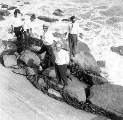 Photograph of men standing on riprap at base of Causeway