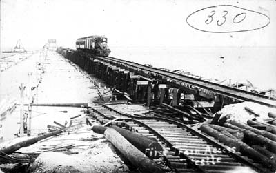 Photograph labeled First Train Across Trestle