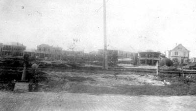 Photograph of wrecked houses along Seawall Boulevard 